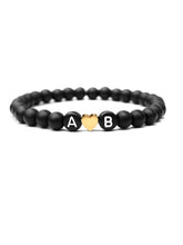 Partnerarmband Black Heart mit zwei Buchstaben und einem Edelstahl Herz in gold aus Natursteinperlen in schwarz von Lymaja Jewelry