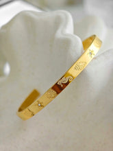 Goldener Armreif mit graviertem Seestern, Muschel, Seepferdchen und kleinen Zirkonia-Steinen